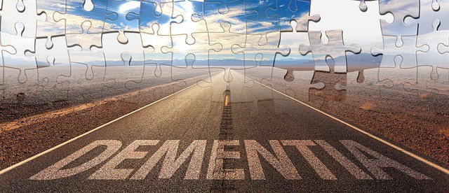 Dementia written on a road with missing puzzle pieces on a horizon